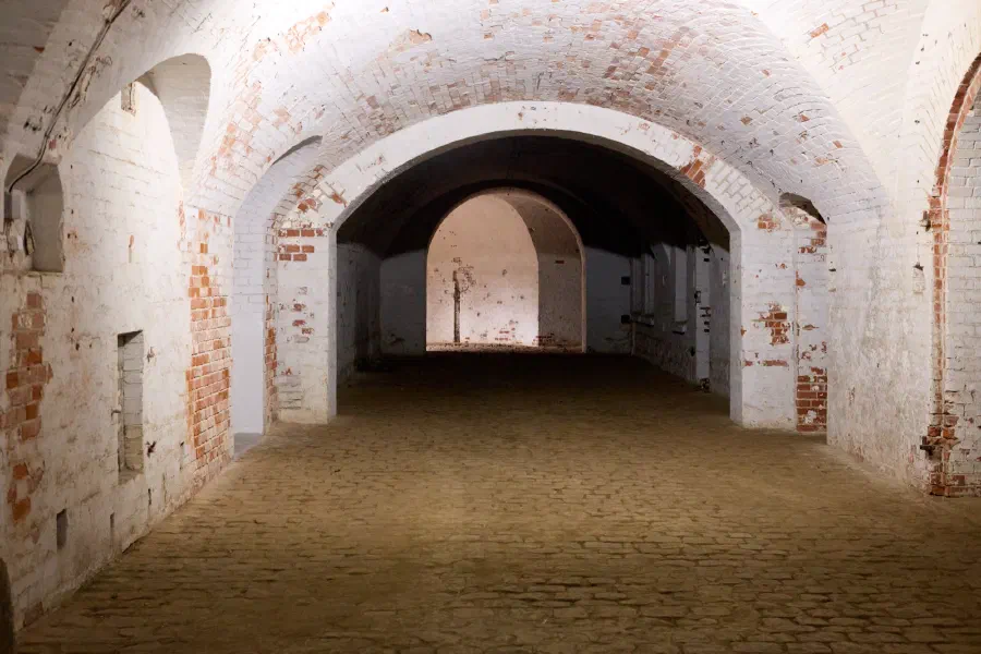 Old brick fortress underground corridor arched vault historic architecture interior