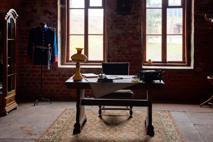 Vintage office interior with desk typewriter and military uniform historical room